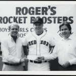Boston Red Sox Roger Clemens, center, posing with two unidentified men holding a donation check at “Roger’s Rocket Boosters” event.