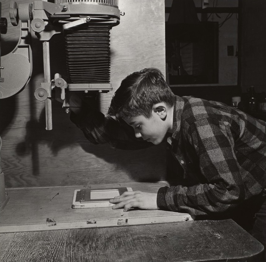 Paul Mahan from the Boys' Clubs of Boston using an enlarger at a photographic laboratory
