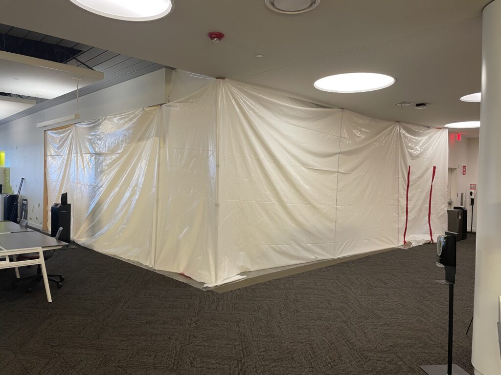 A large white tarp covers a section of the first floor of Snell Library, where the temporary entrance will be created.